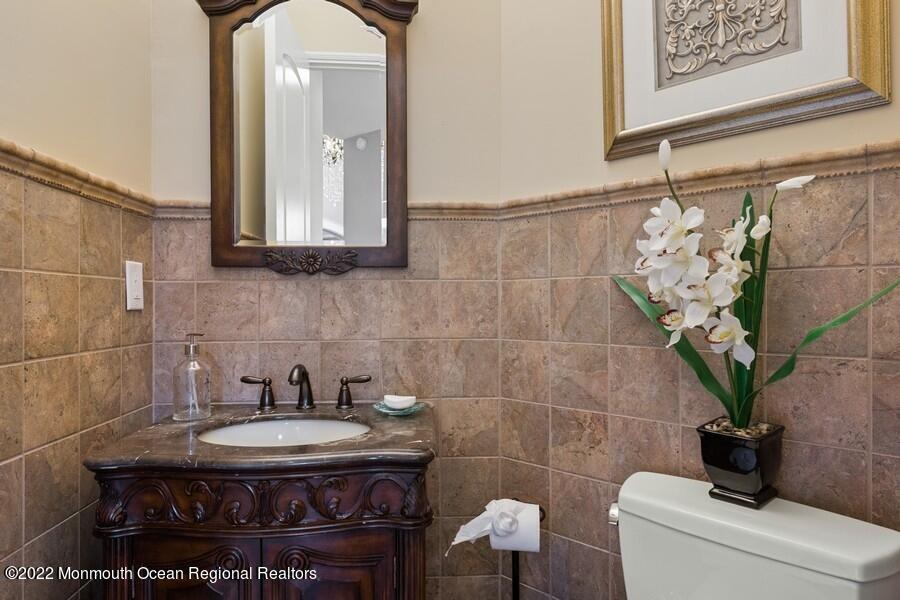 72 Edgewood Road Morganville, NJ 07751 - Photo 27 of 86 a bathroom with a granite countertop sink a toilet and a mirror