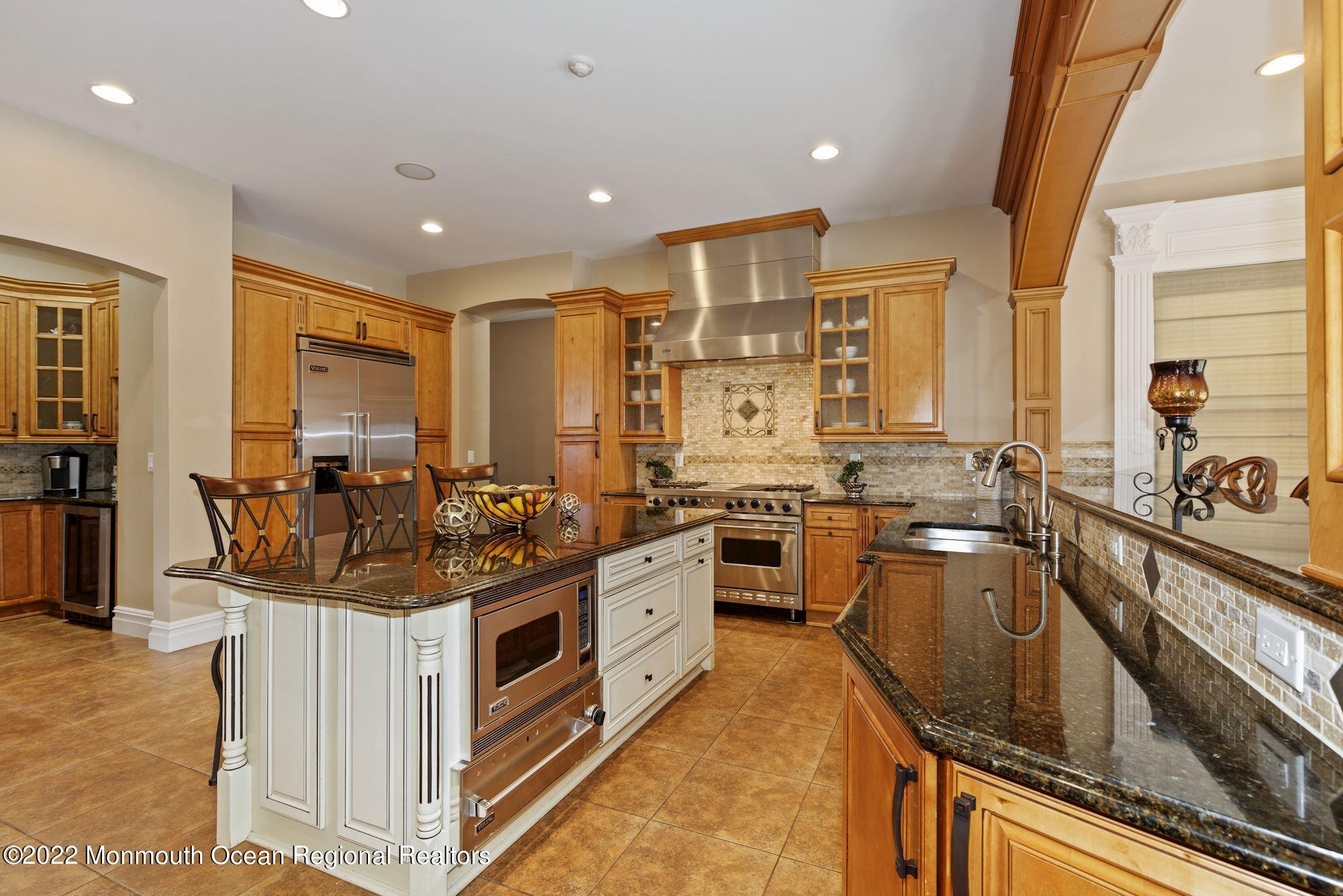 72 Edgewood Road Morganville, NJ 07751 - Photo 30 of 86 a kitchen with stainless steel appliances a stove sink and cabinets