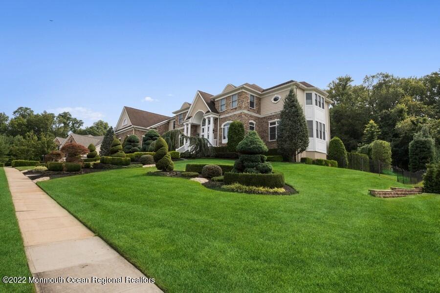 72 Edgewood Road Morganville, NJ 07751 - Photo 3 of 86 a front view of a house with a yard table and chairs