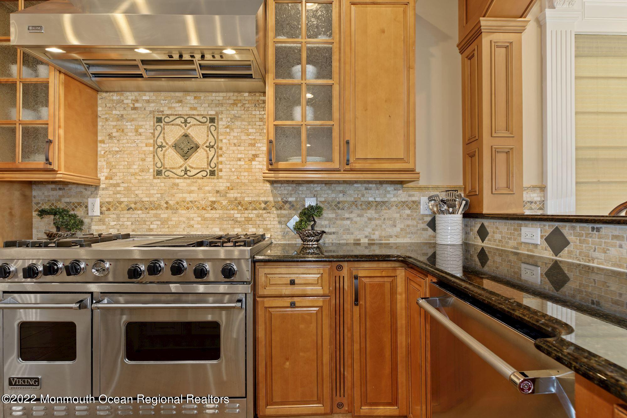 72 Edgewood Road Morganville, NJ 07751 - Photo 32 of 86 a kitchen with granite countertop a sink stove and cabinets