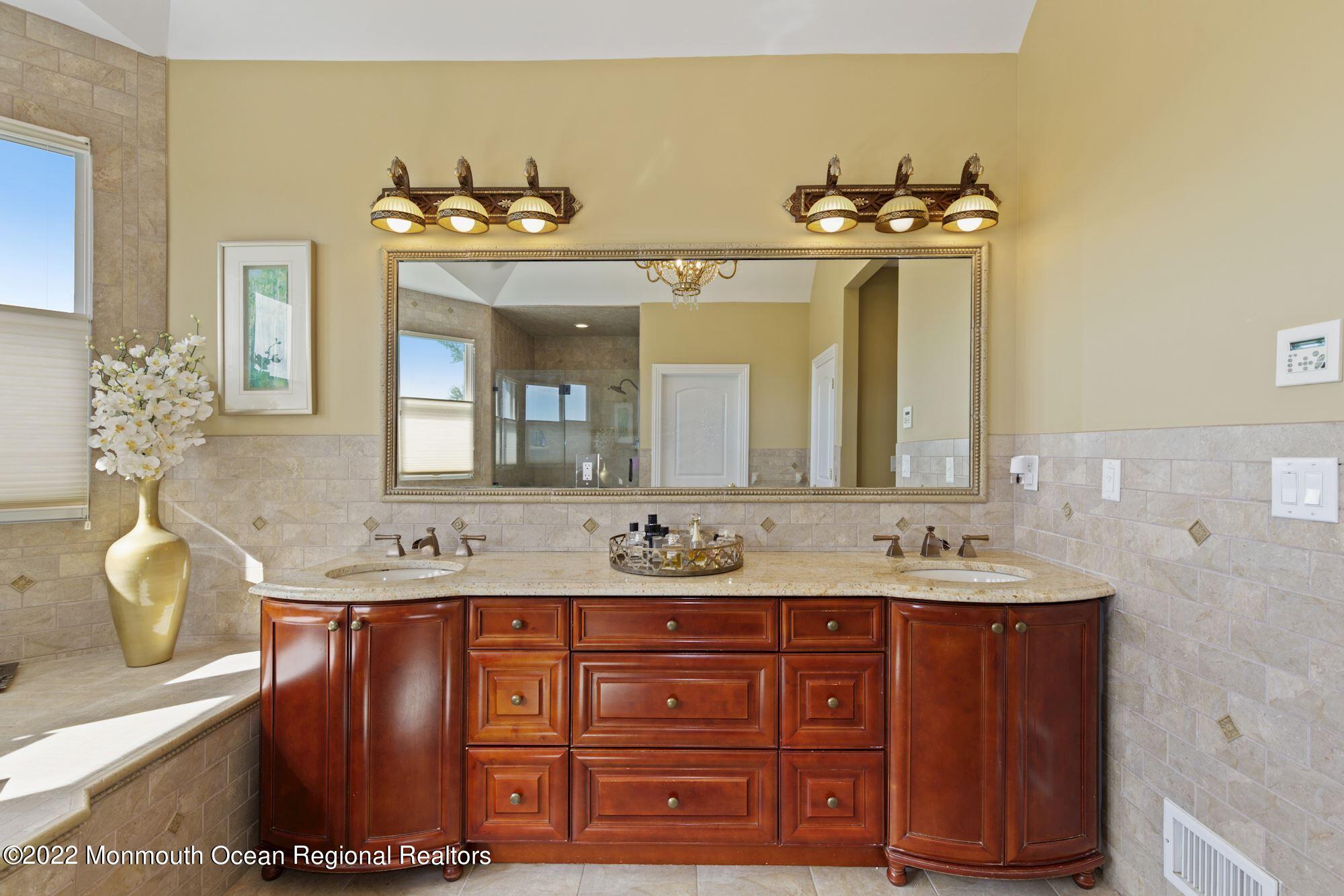 72 Edgewood Road Morganville, NJ 07751 - Photo 45 of 86 a bathroom with a double vanity sink and a mirror