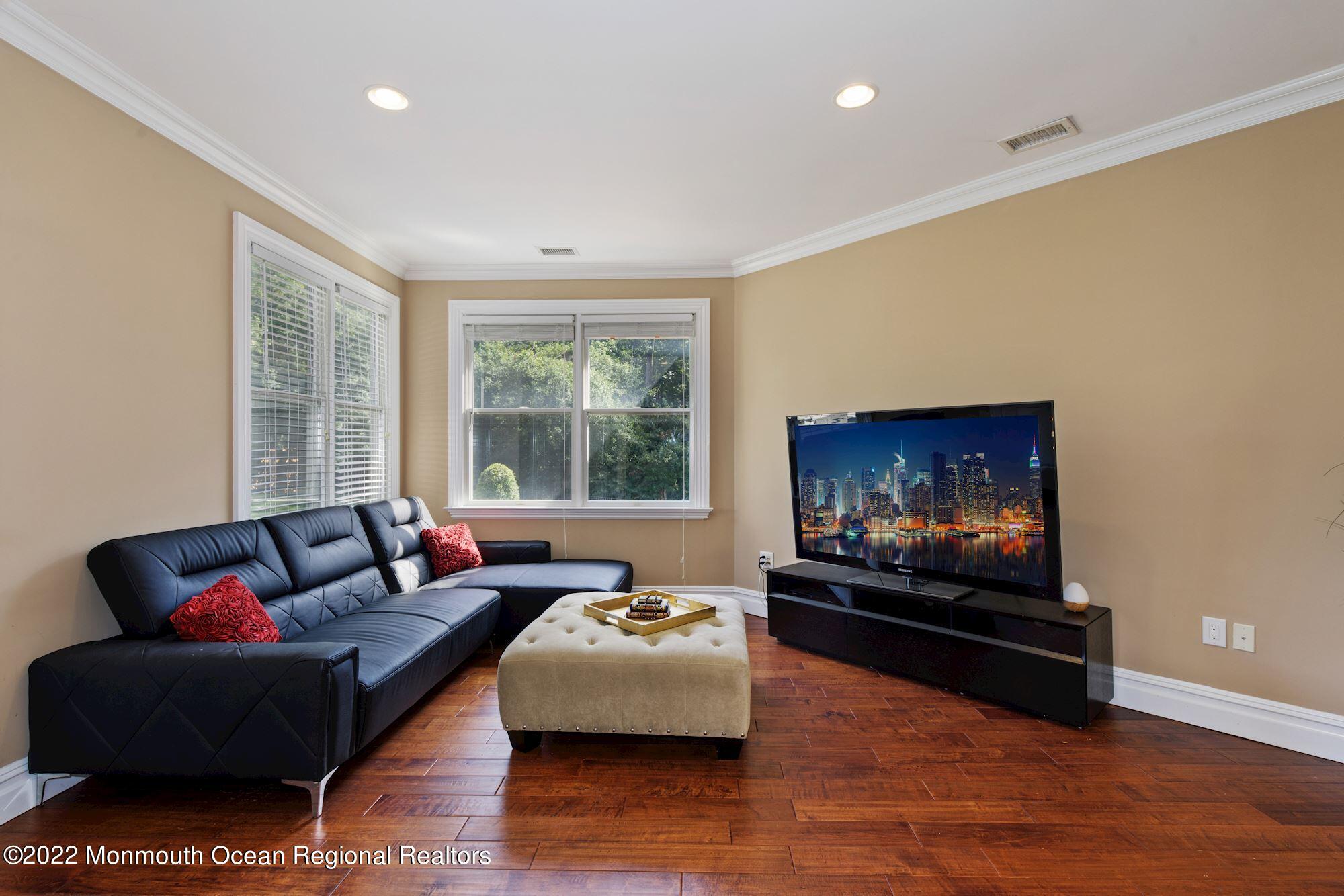 72 Edgewood Road Morganville, NJ 07751 - Photo 47 of 86 a living room with furniture and a flat screen tv
