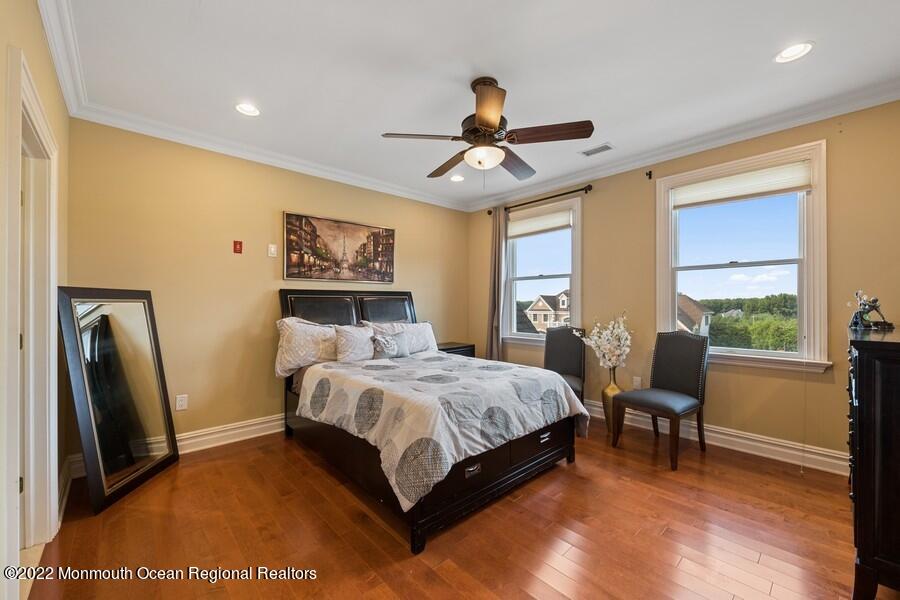 72 Edgewood Road Morganville, NJ 07751 - Photo 51 of 86 a bedroom with a bed wooden floor and window