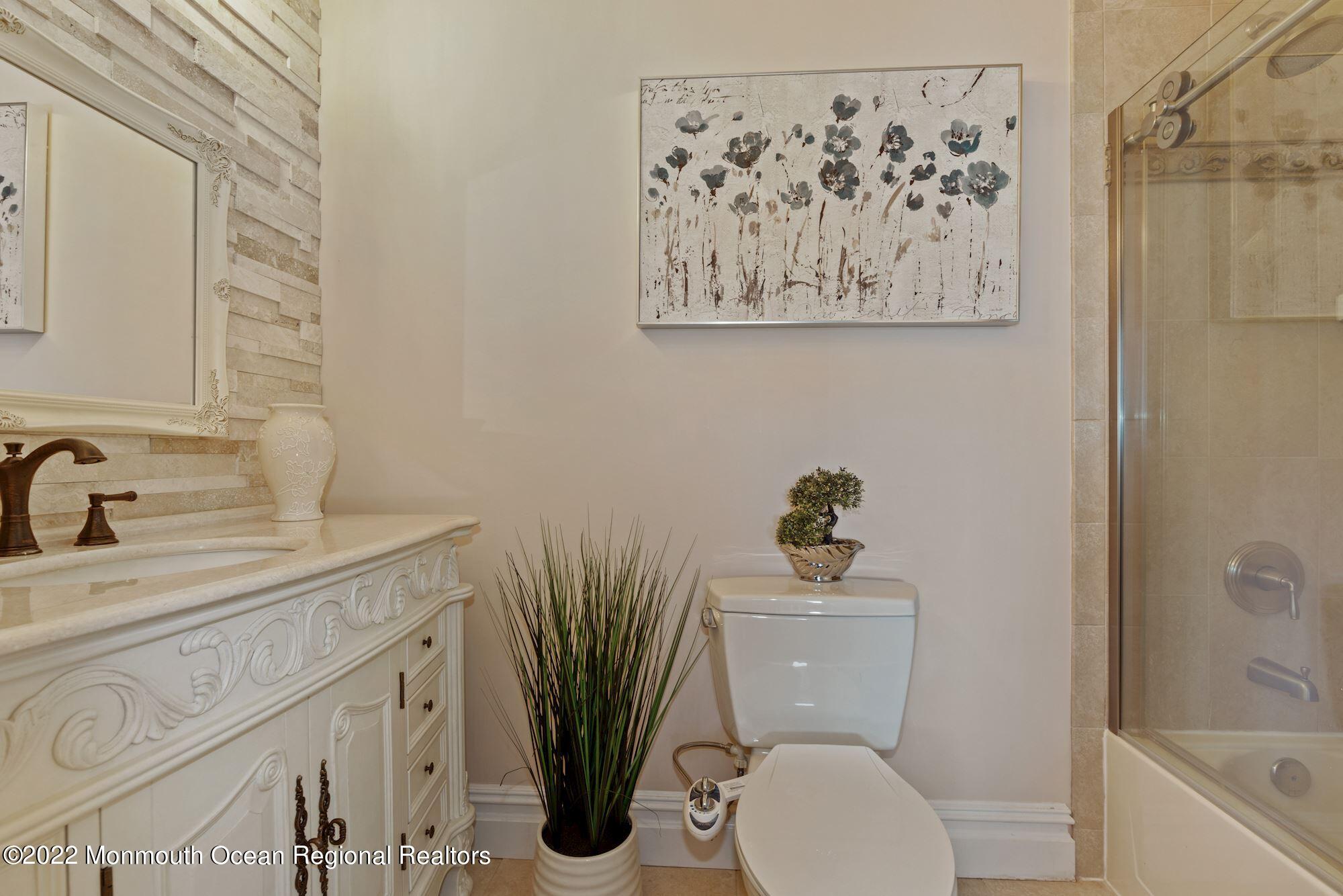 72 Edgewood Road Morganville, NJ 07751 - Photo 52 of 86 a bathroom with a toilet sink and mirror