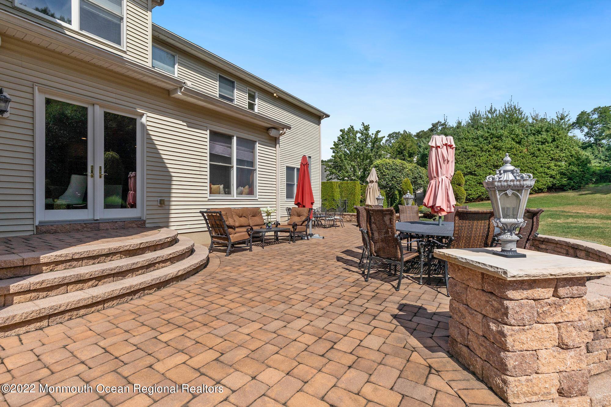 72 Edgewood Road Morganville, NJ 07751 - Photo 58 of 86 a view of a dinning tables and chairs in a backyard of the house