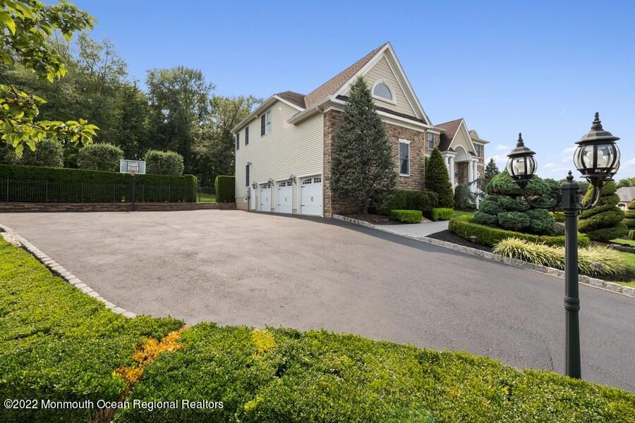 72 Edgewood Road Morganville, NJ 07751 - Photo 6 of 86 a front view of a house with a yard and garage