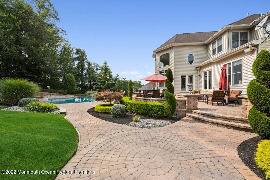 72 Edgewood Road Morganville, NJ 07751 - Photo 62 of 86 a view of a white house with a big yard and potted plants