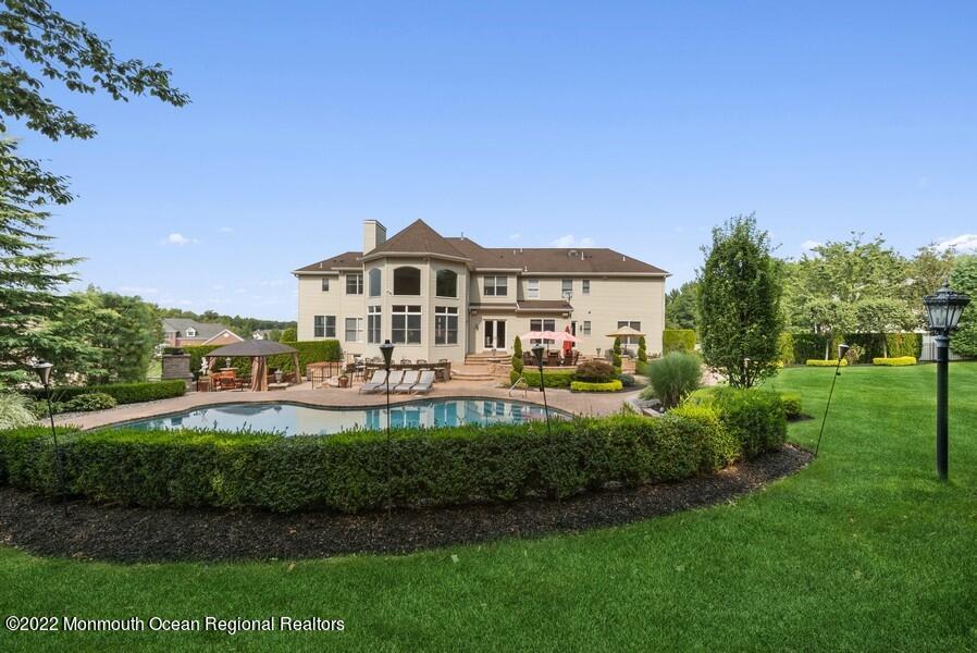 72 Edgewood Road Morganville, NJ 07751 - Photo 73 of 86 a front view of a house with a garden and plants