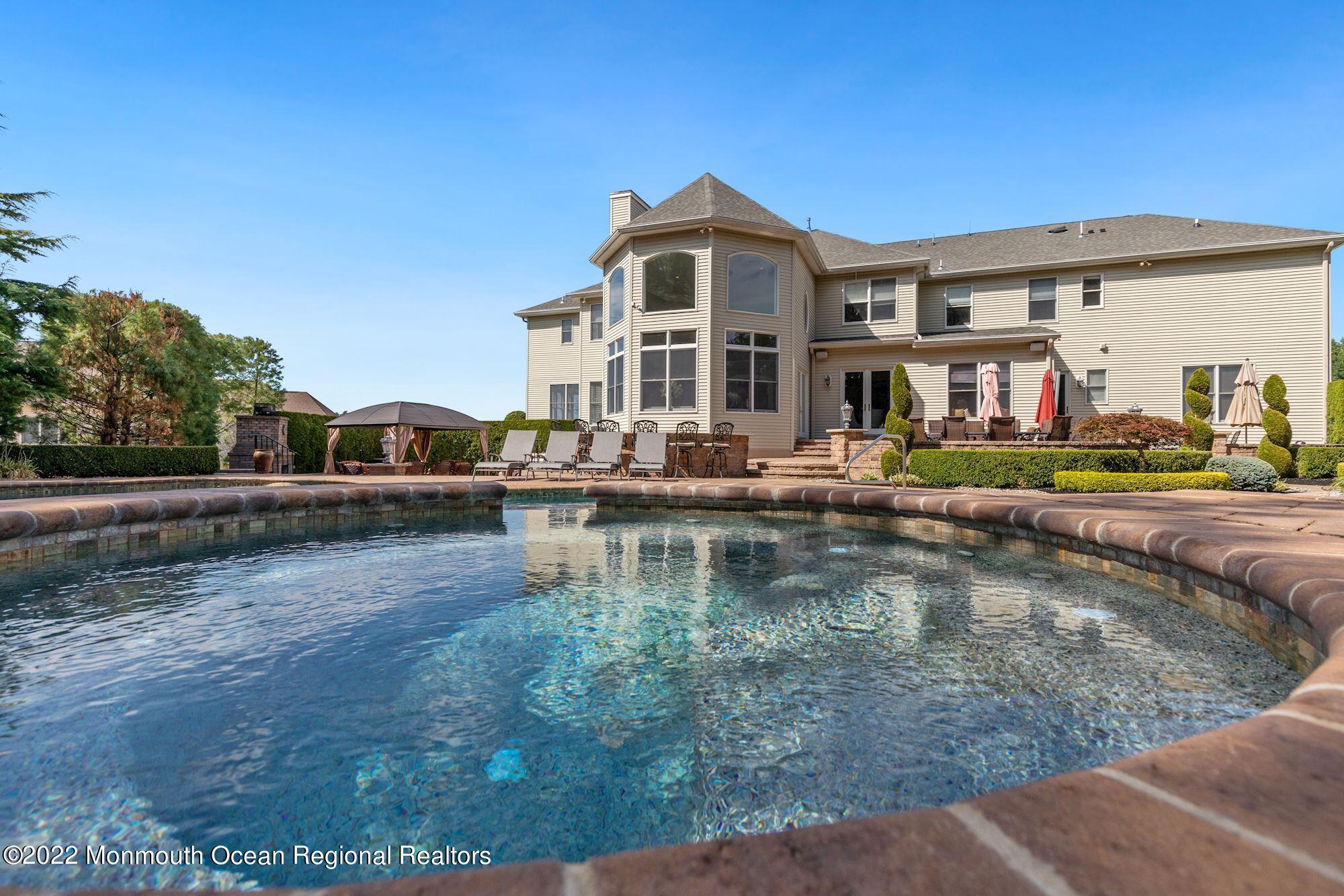 72 Edgewood Road Morganville, NJ 07751 - Photo 77 of 86 a house with river in front of it