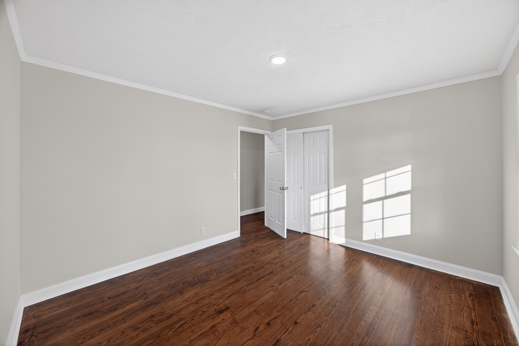 2136 West Broad Street Cookeville, TN 38501 - Photo 18 of 33 an empty room with wooden floor and windows