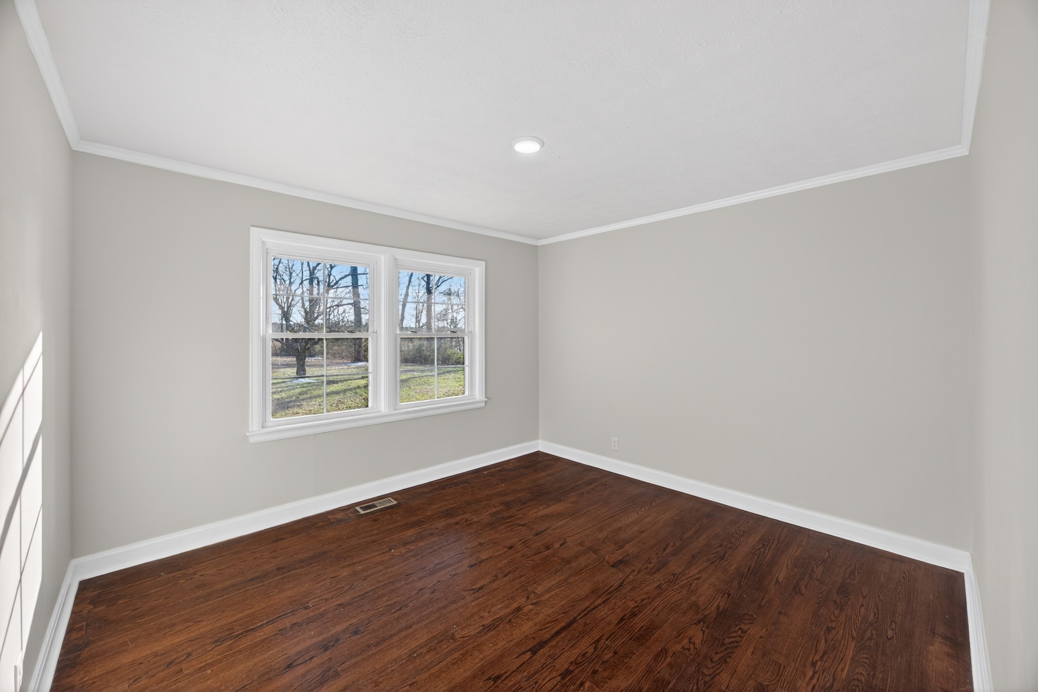2136 West Broad Street Cookeville, TN 38501 - Photo 19 of 33 an empty room with wooden floor and windows