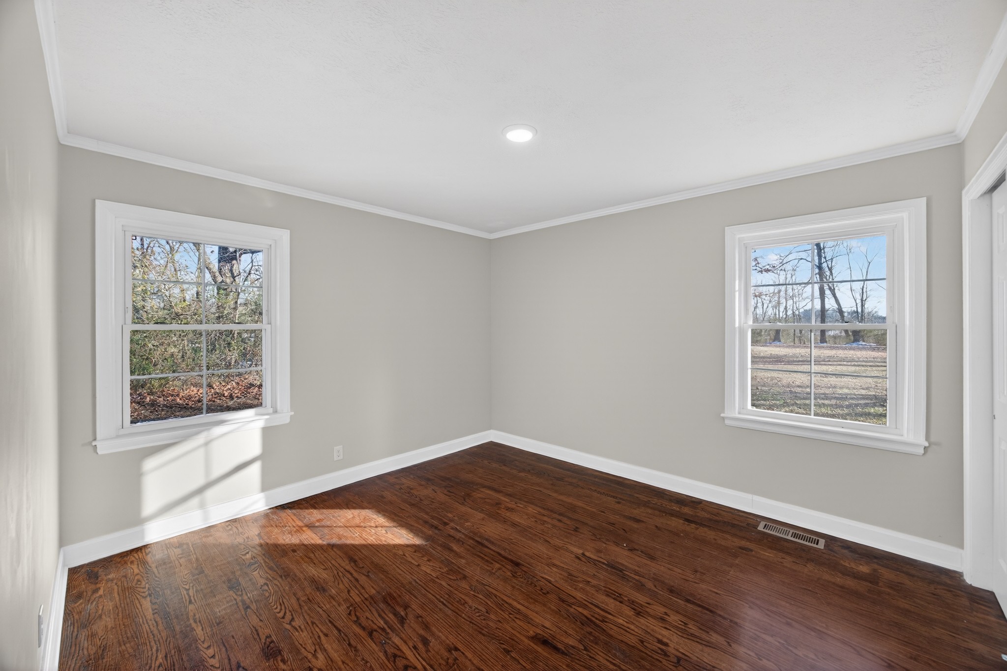 2136 West Broad Street Cookeville, TN 38501 - Photo 21 of 33 an empty room with wooden floor and windows