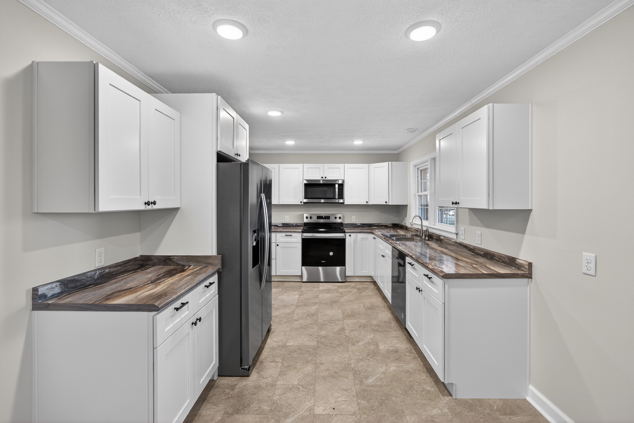 2136 West Broad Street Cookeville, TN 38501 - Photo 10 of 33 a large kitchen with stainless steel appliances granite countertop a stove and a refrigerator