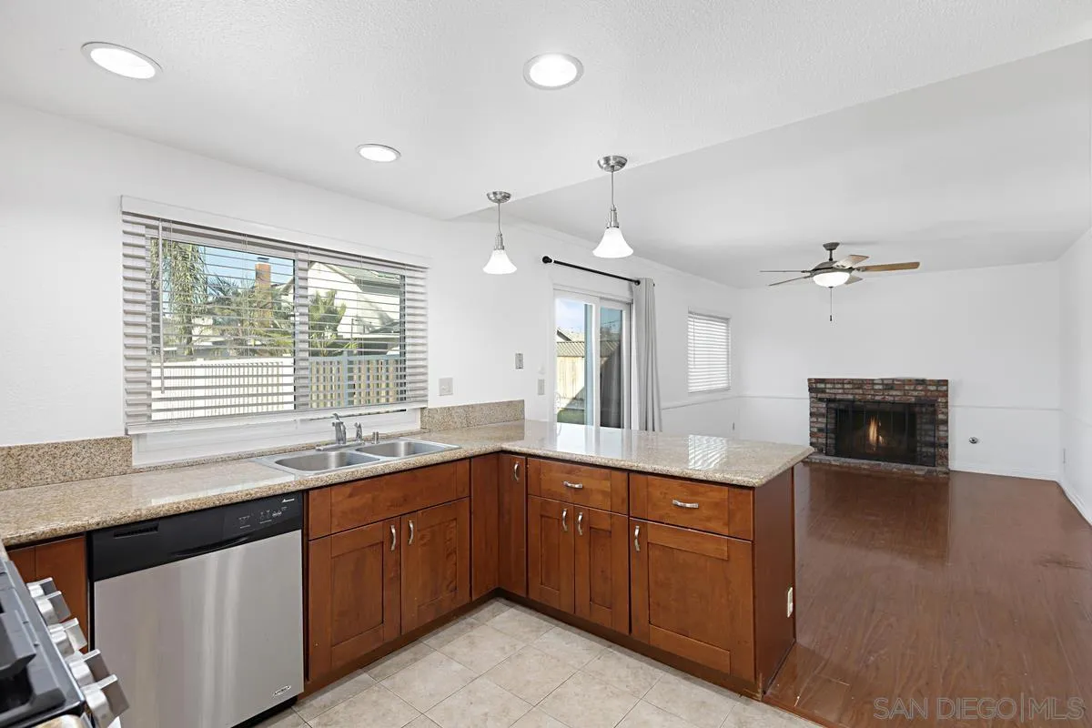 10148 East Glendon Circle Santee, CA 92071 - Photo 12 of 33 a kitchen with a sink and dishwasher with wooden floor