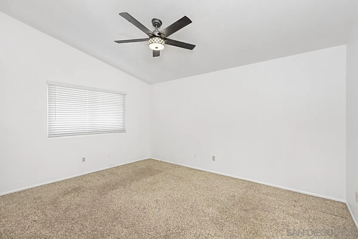 10148 East Glendon Circle Santee, CA 92071 - Photo 16 of 33 an empty room with a window and a fan