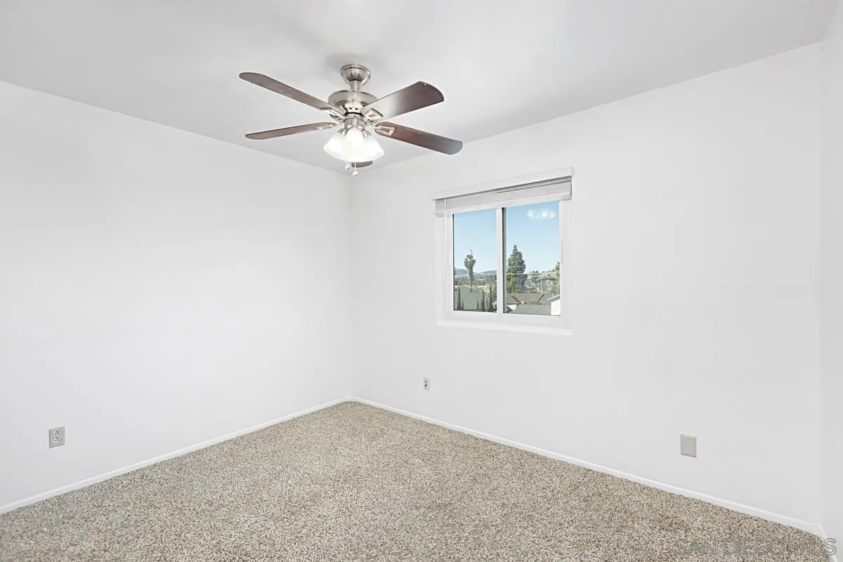 10148 East Glendon Circle Santee, CA 92071 - Photo 20 of 33 an empty room with a window and a fan