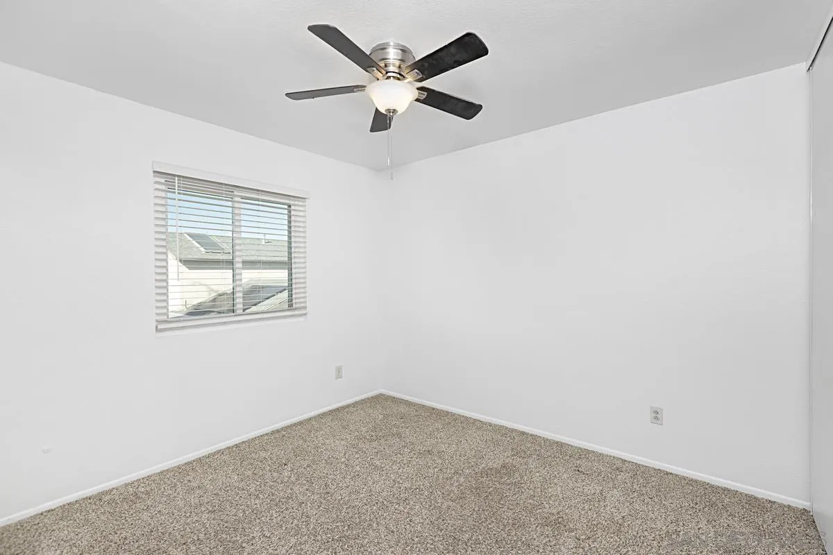 10148 East Glendon Circle Santee, CA 92071 - Photo 22 of 33 an empty room with a window and a fan