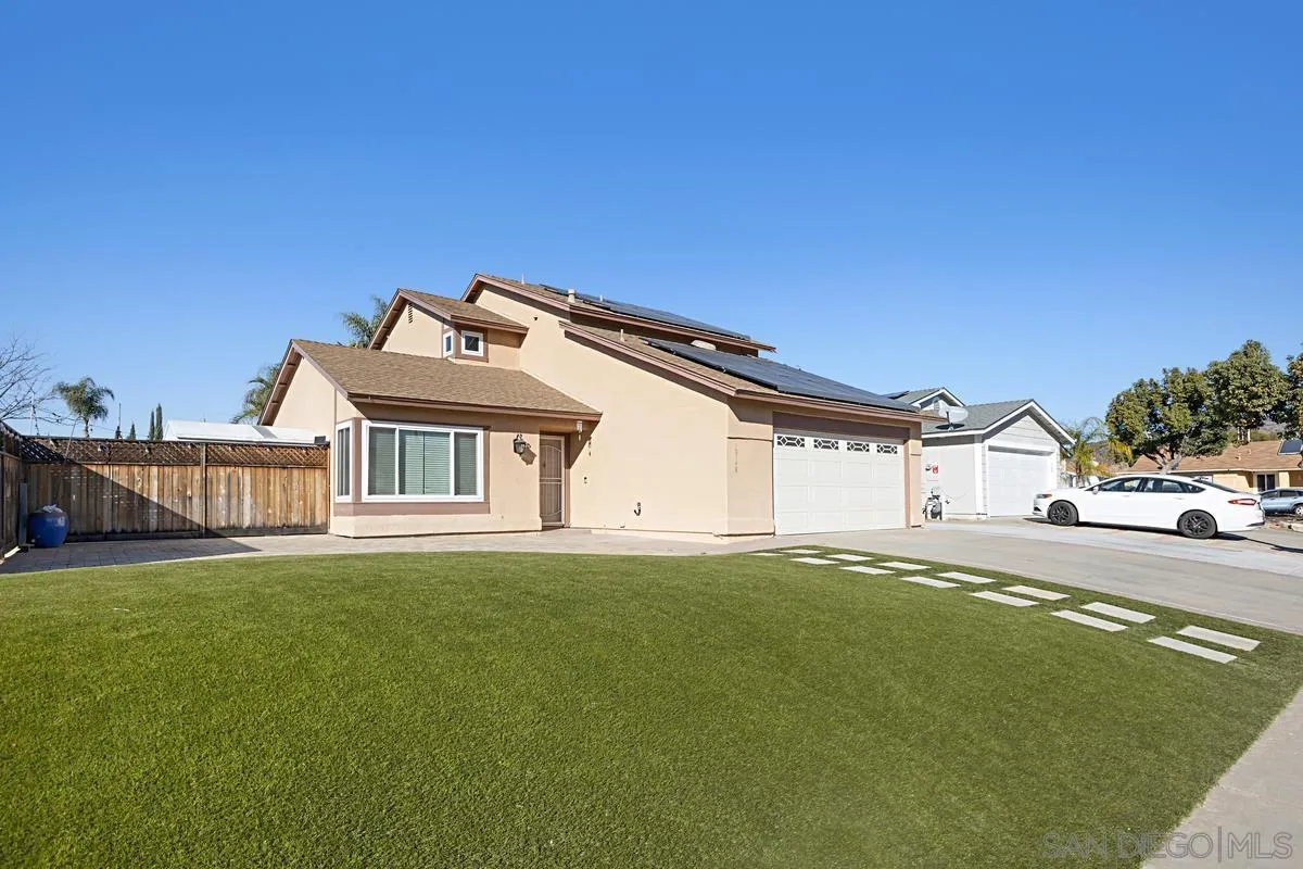 10148 East Glendon Circle Santee, CA 92071 - Photo 29 of 33 a front view of a house with a garden and yard