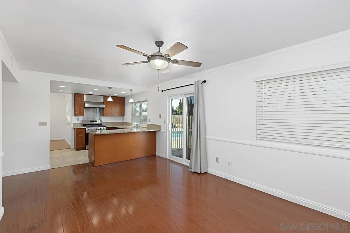 10148 East Glendon Circle Santee, CA 92071 - Photo 10 of 33 a kitchen with stainless steel appliances kitchen island a refrigerator sink and white cabinets