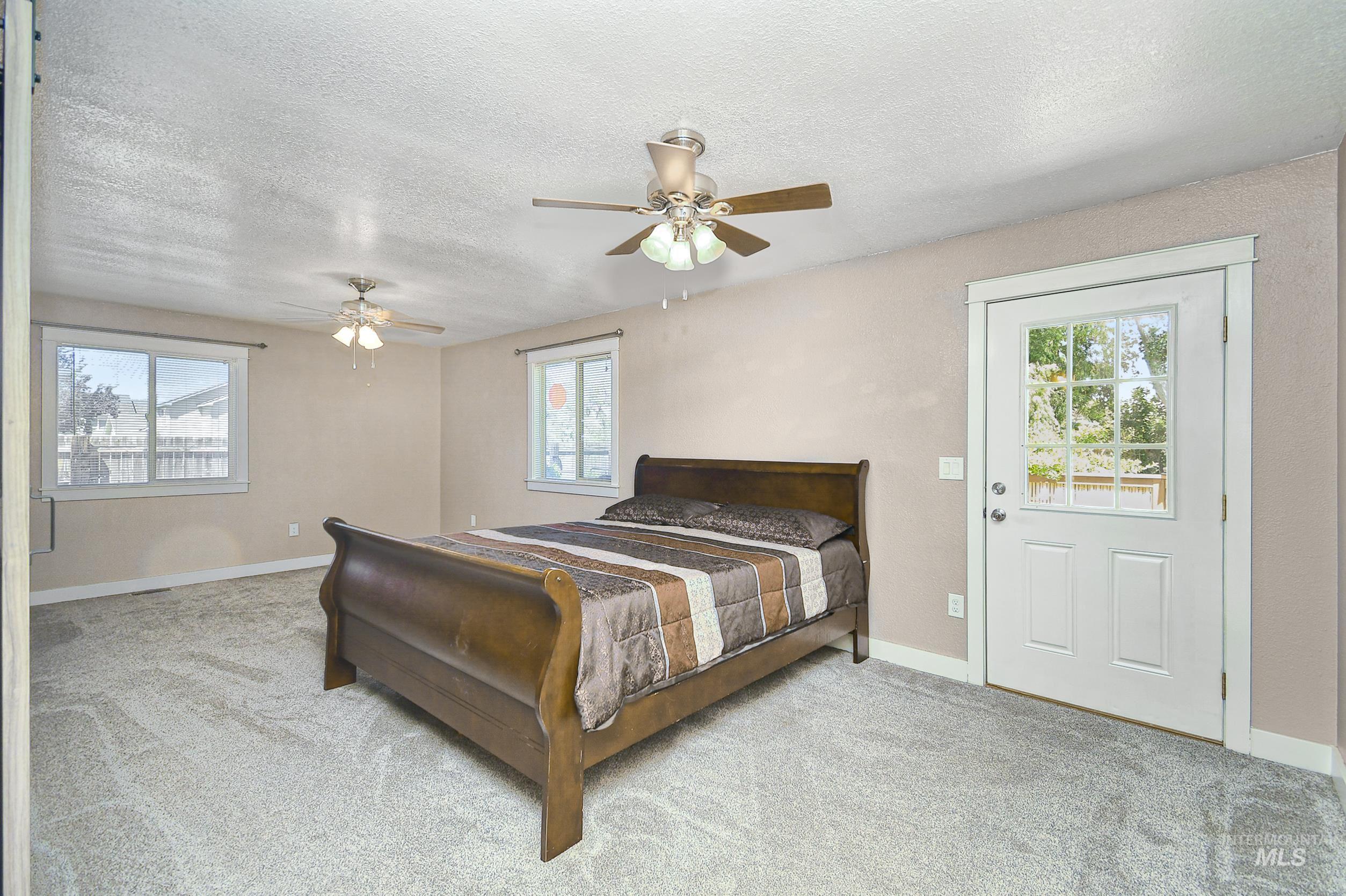 1108 East Ustick Road Caldwell, ID 83607 - Photo 22 of 30 Spacious room with light-colored walls and grey patterned carpet
