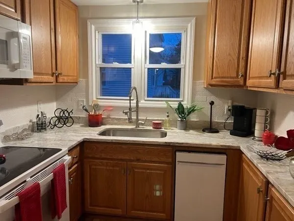 a kitchen with stainless steel appliances granite countertop a sink stove and cabinets