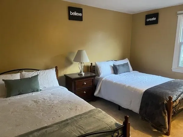 a bedroom with a bed and lamp