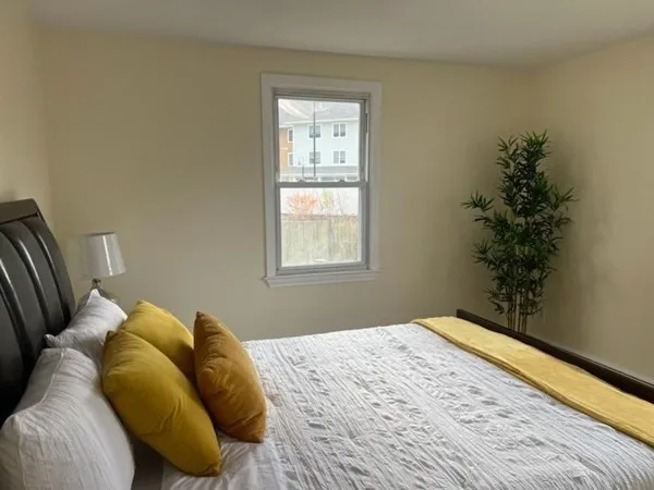 a bedroom with a bed and a window