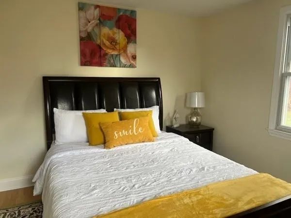 a bed sitting in a bedroom next to a window