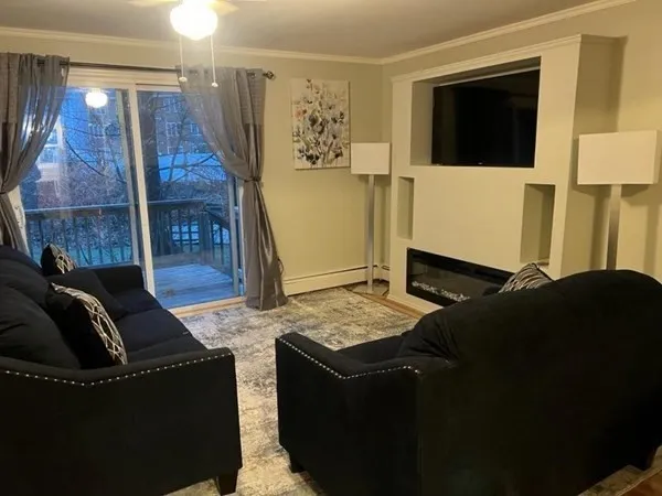 a living room with couches and a flat screen tv