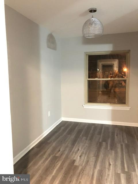 3835 St Barnabas Road, Unit 201 Suitland, MD 20746 - Photo 9 of 12 a view of wooden floor and a chandelier in a room