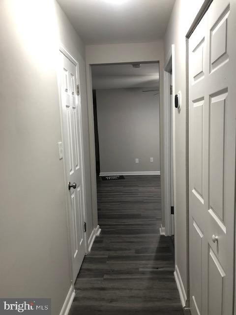 3835 St Barnabas Road, Unit 201 Suitland, MD 20746 - Photo 10 of 12 a view of a hallway with wooden floor and staircase