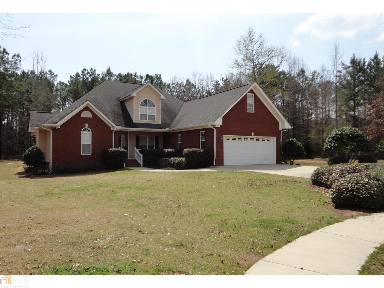 201 Willow Ridge Lane Jackson, GA 30233 - Photo 1 of 1 a front view of a house with a yard and garage