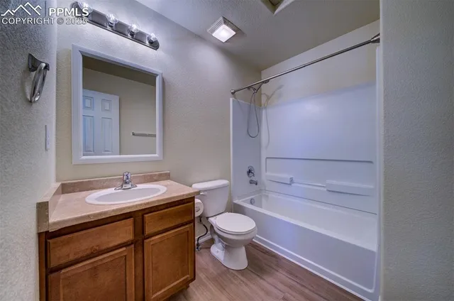 a view of a room with wooden floor and a staircase