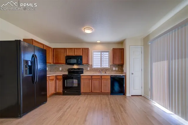 a kitchen with stainless steel appliances granite countertop a refrigerator stove and sink