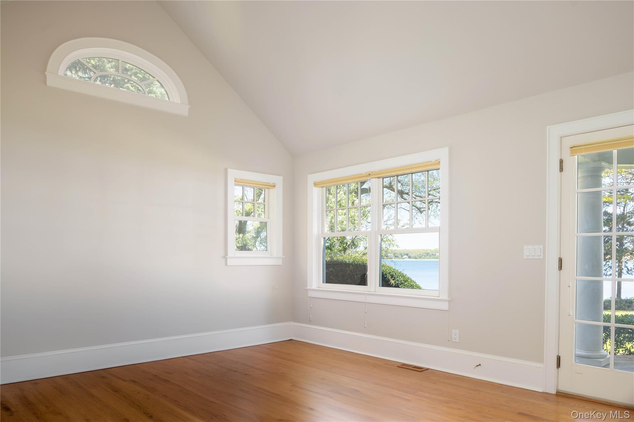 5055 New Suffolk Road New Suffolk, NY 11956 - Photo 21 of 42 a view of an empty room with wooden floor and a window