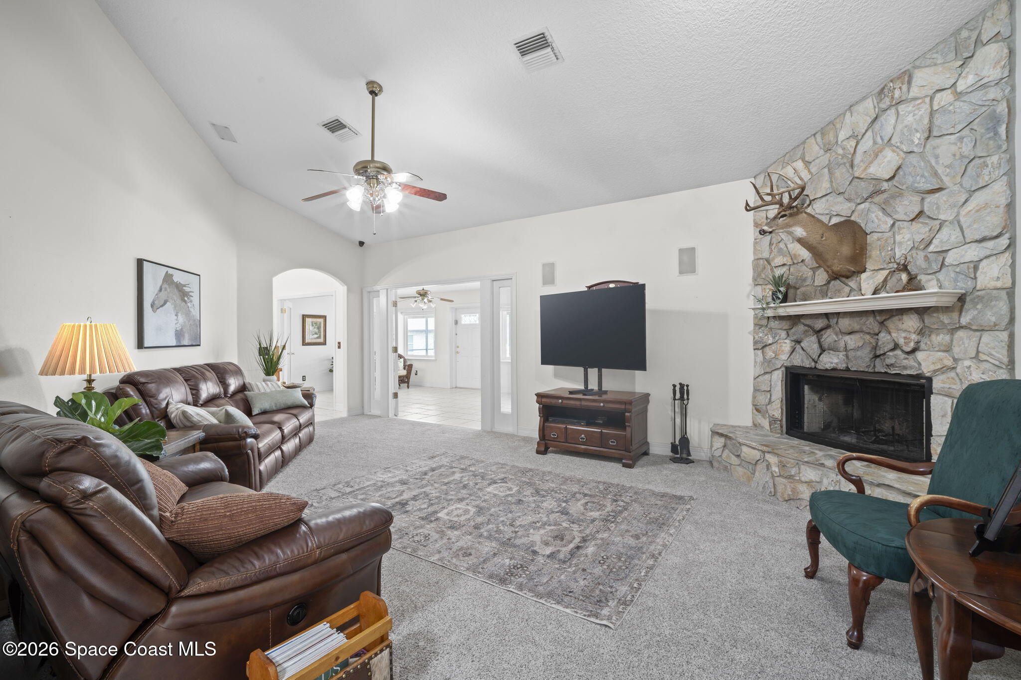 3125 Davis Road Mims, FL 32754 - Photo 16 of 47 a living room with furniture a fireplace and a flat screen tv
