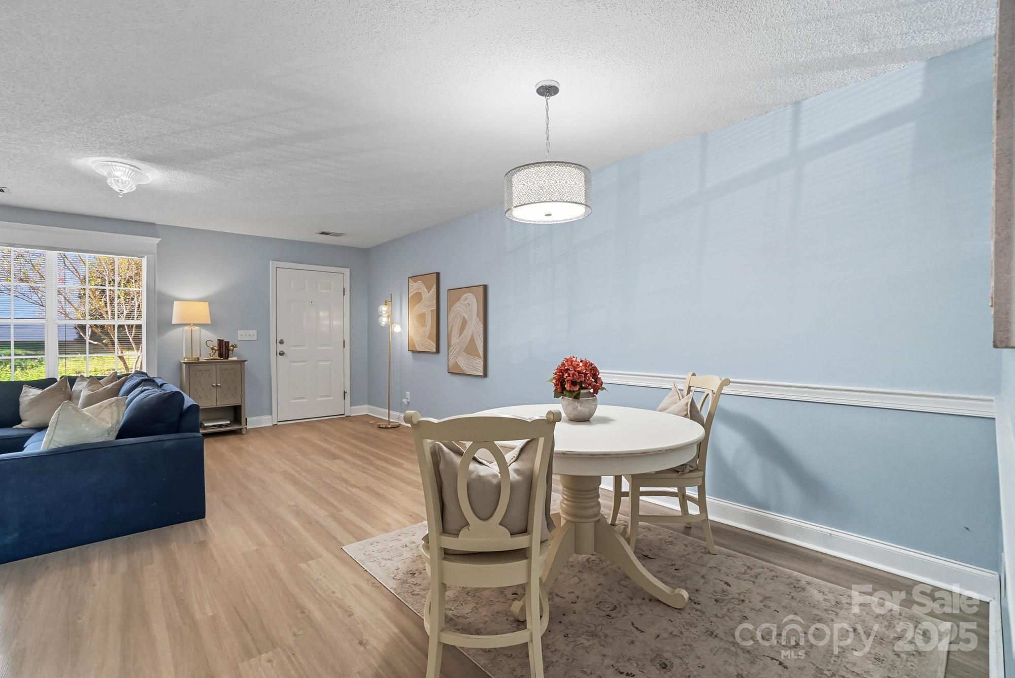 9166 Exbury Court Charlotte, NC 28269 - Photo 11 of 31 a living room with furniture and a table