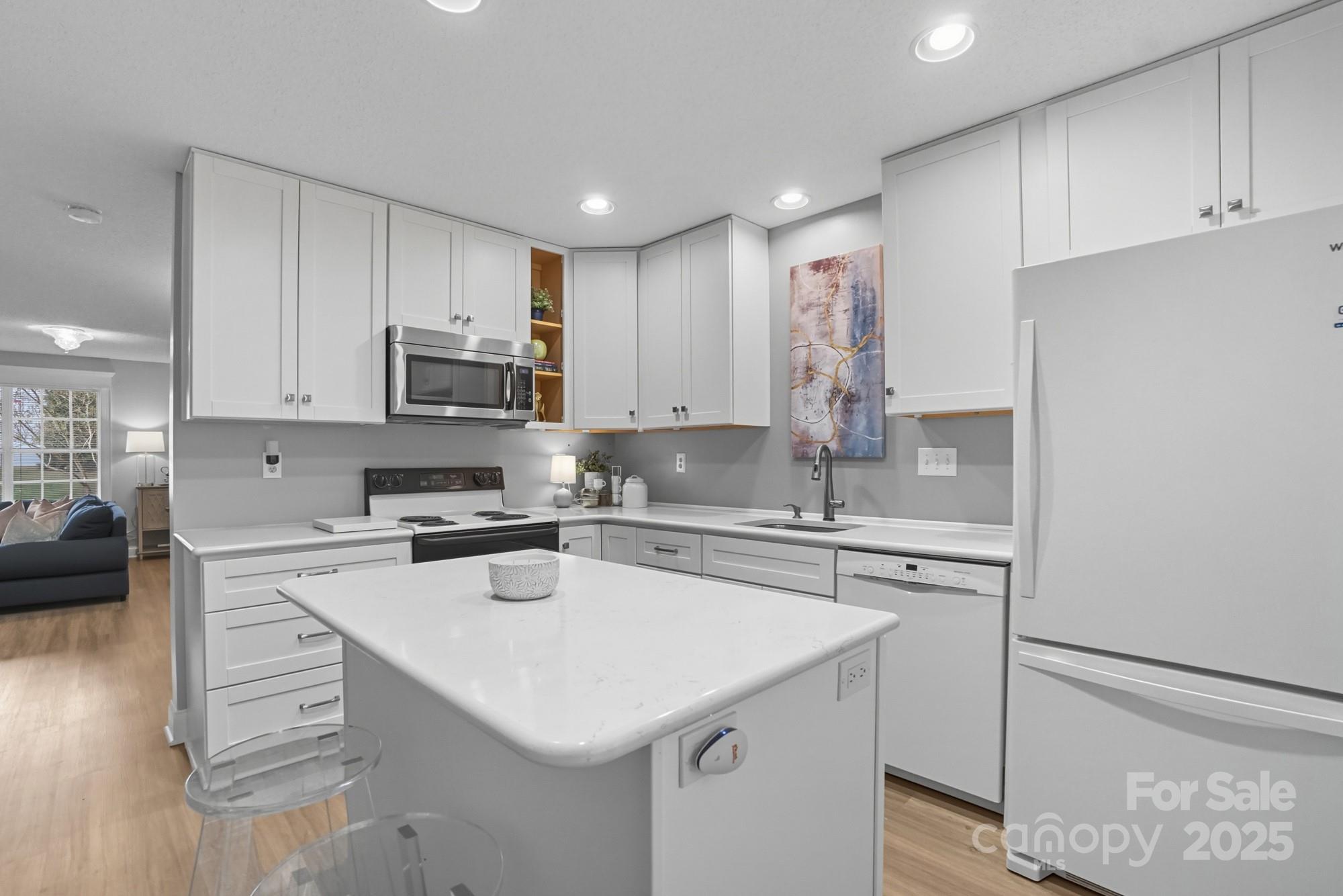 9166 Exbury Court Charlotte, NC 28269 - Photo 13 of 31 a kitchen with a sink a stove and cabinets