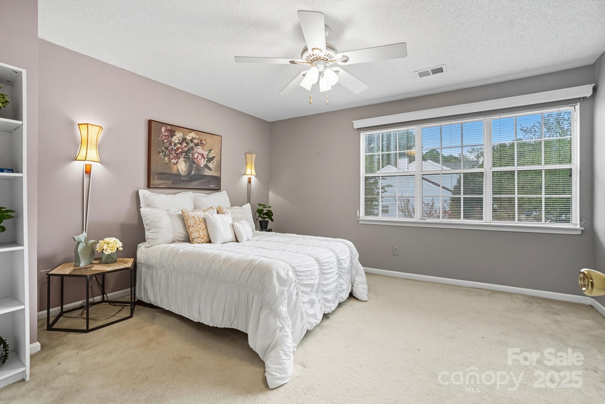 9166 Exbury Court Charlotte, NC 28269 - Photo 19 of 31 a spacious bedroom with a bed and a window