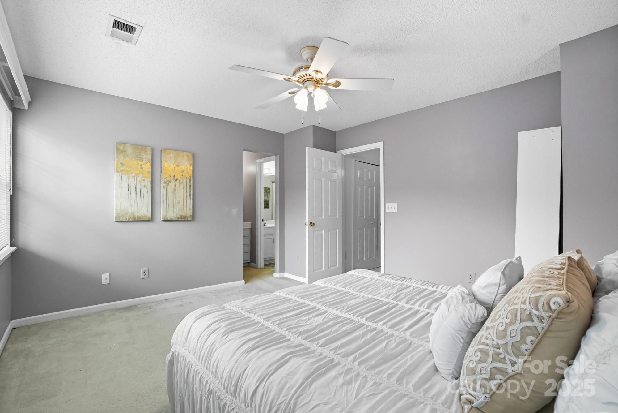 9166 Exbury Court Charlotte, NC 28269 - Photo 21 of 31 a bedroom with a large bed and a chandelier