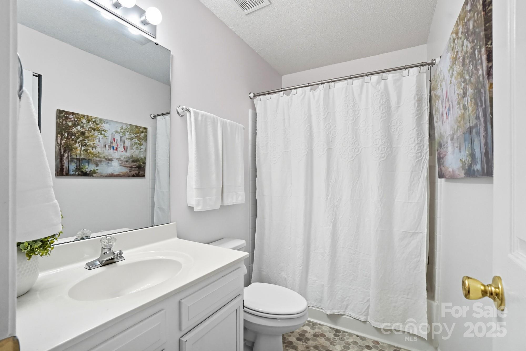 9166 Exbury Court Charlotte, NC 28269 - Photo 23 of 31 a bathroom with a sink toilet and shower