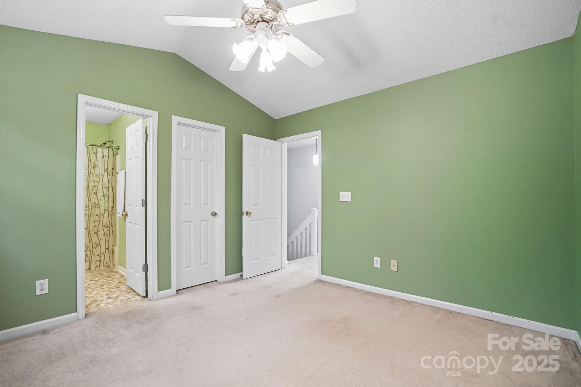 9166 Exbury Court Charlotte, NC 28269 - Photo 25 of 31 an empty room with closet and a chandelier fan