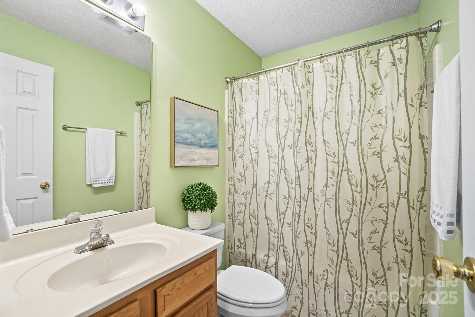 9166 Exbury Court Charlotte, NC 28269 - Photo 27 of 31 a bathroom with a sink toilet and shower