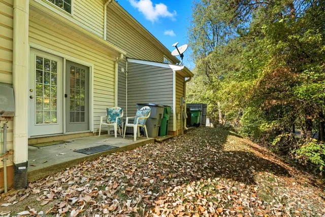 a backyard of a house with table and chairs