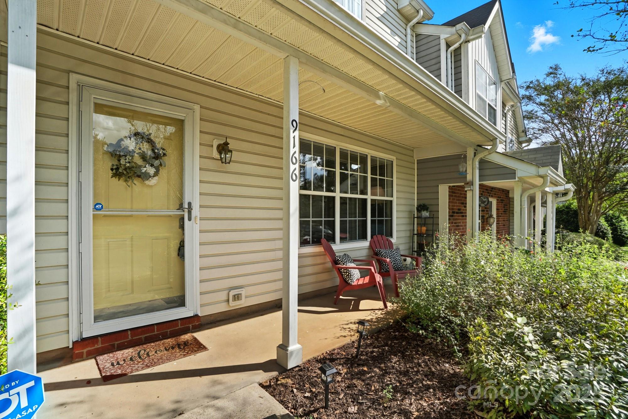 9166 Exbury Court Charlotte, NC 28269 - Photo 4 of 31 a wooden bench sitting in front of a building