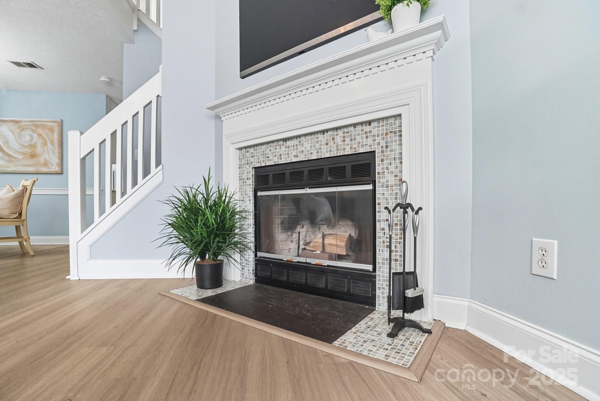 9166 Exbury Court Charlotte, NC 28269 - Photo 9 of 31 a living room with furniture and a fireplace