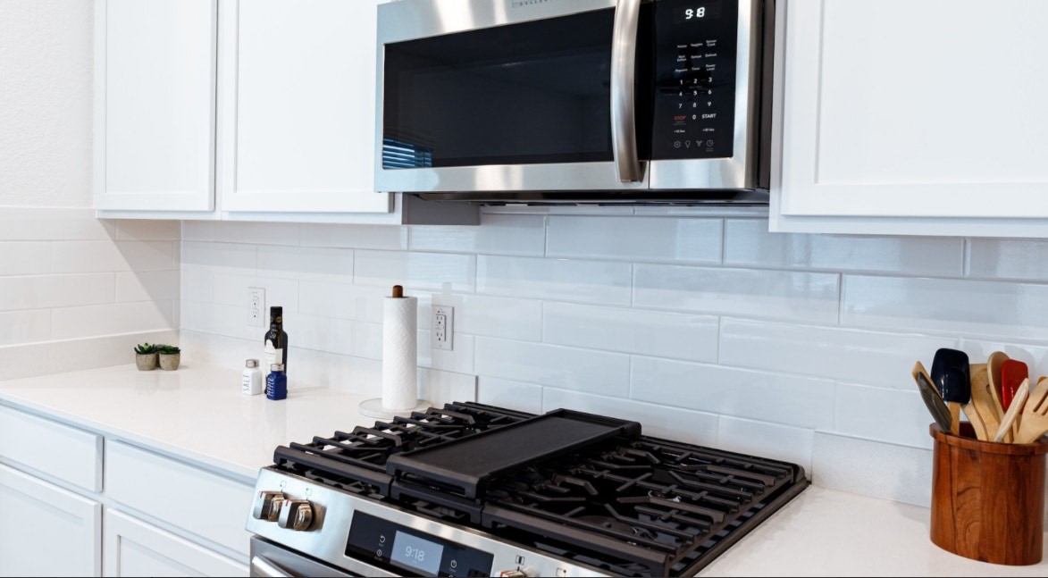 9910 Kilkenny Street Rosharon, TX 77583 - Photo 4 of 10 a kitchen with a stove and a microwave
