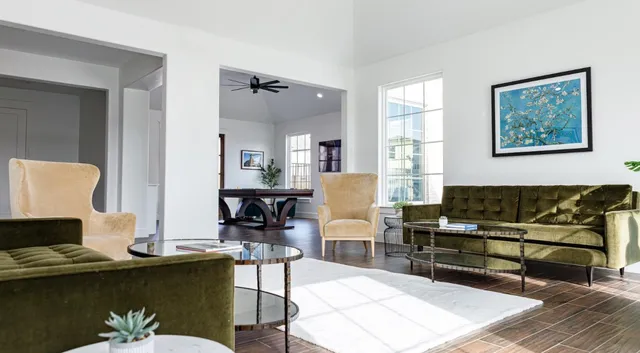 a living room with furniture and wooden floor