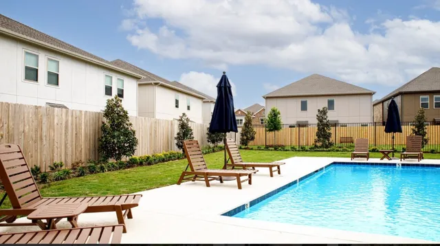 a view of a house with swimming pool garden and patio