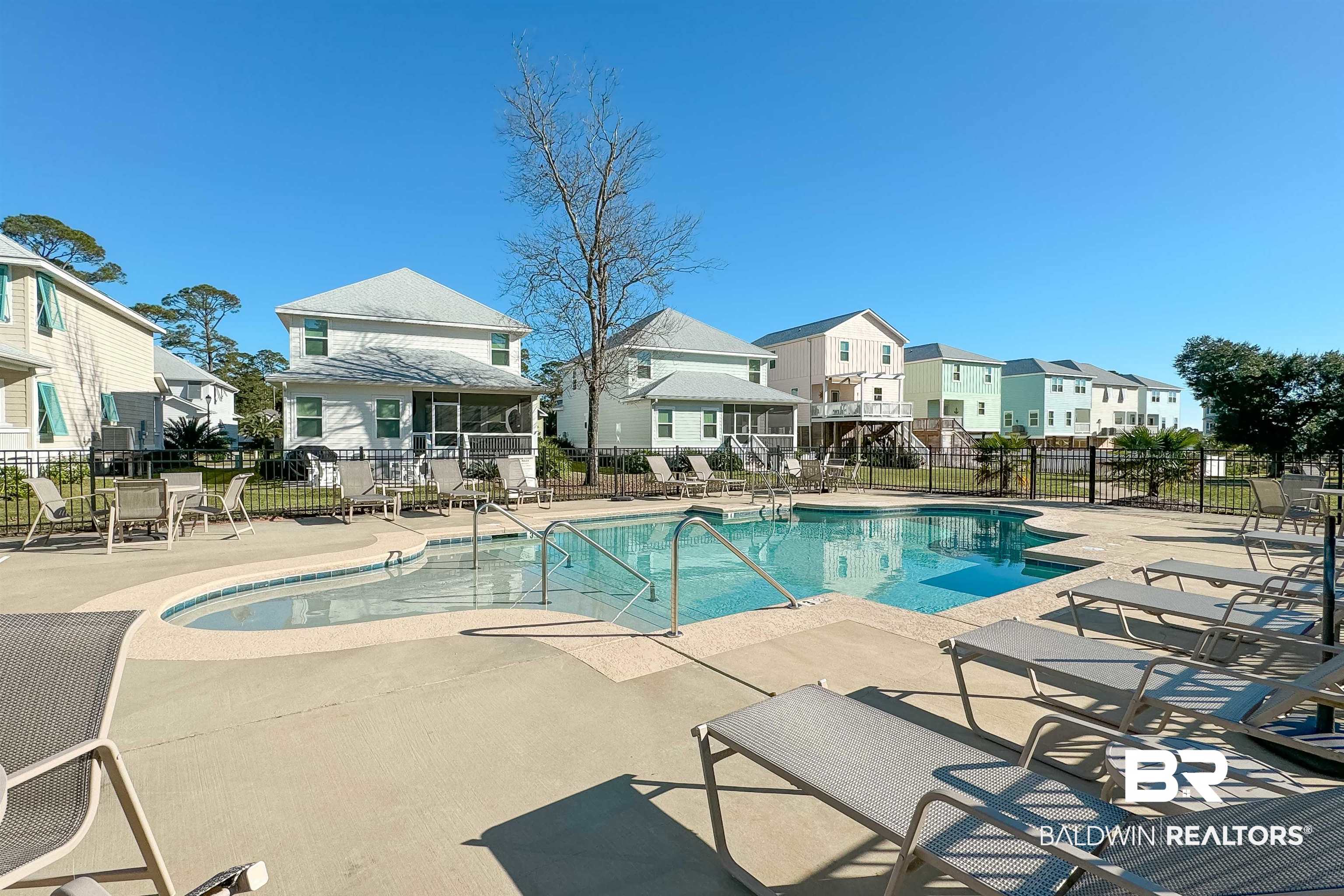 1290 Mako Loop Gulf Shores, AL 36542 - Photo 49 of 50 Community pool featuring a patio area, a residential view, and fence
